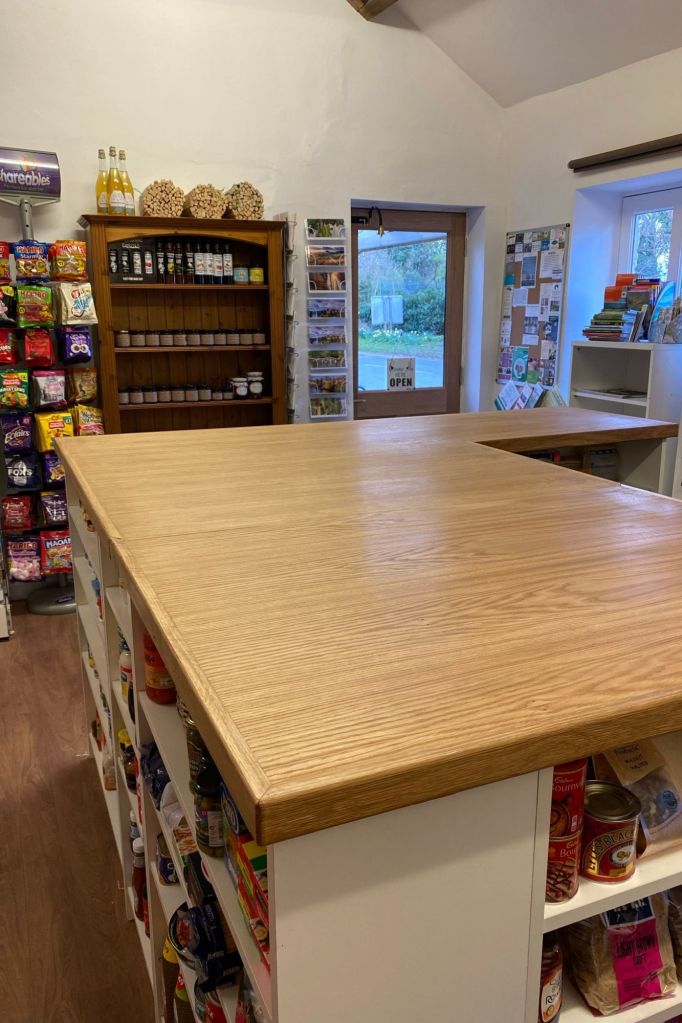 central worksurface in village shop made from oak in Derbyshire