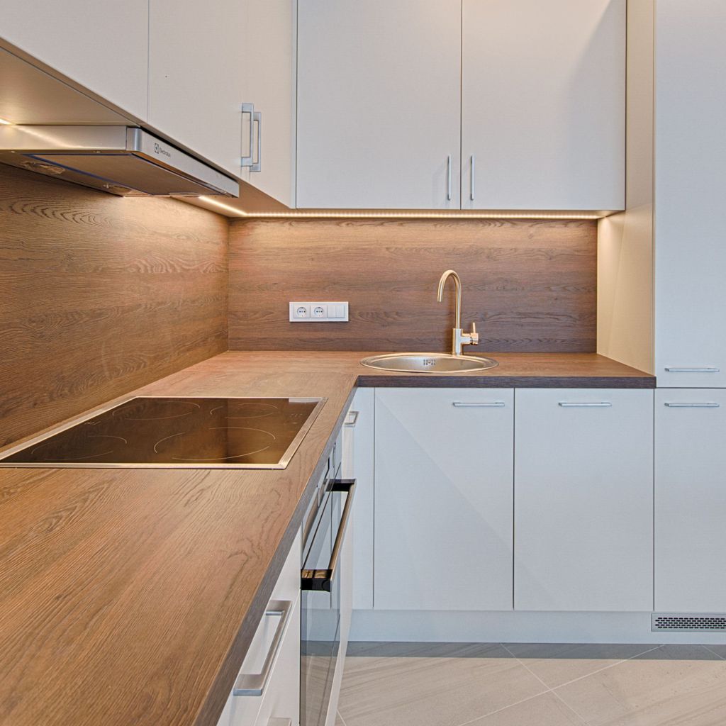 Wooden kitchen worktops in modern kitchen with inbuilt stove and sink